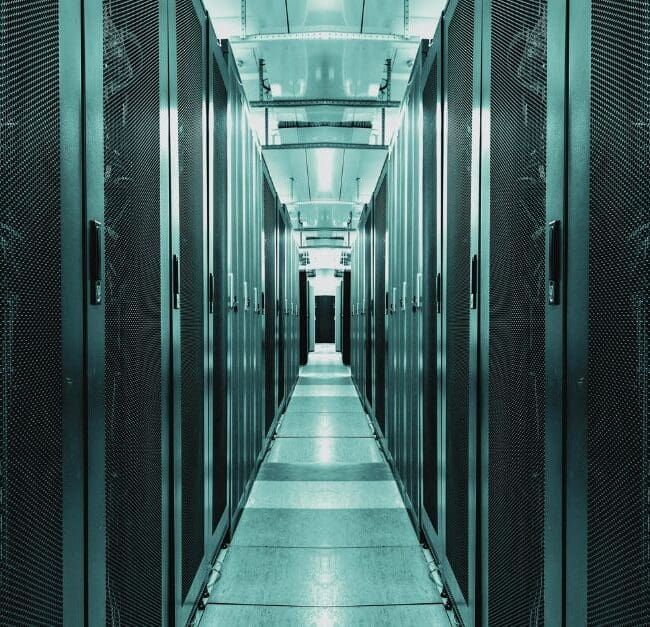 Interior of a modern data centre with rows of server racks, highlighting the importance of efficient, sustainable infrastructure in the digital age. Navitas Resourcing Group connects top talent for green data centre projects.