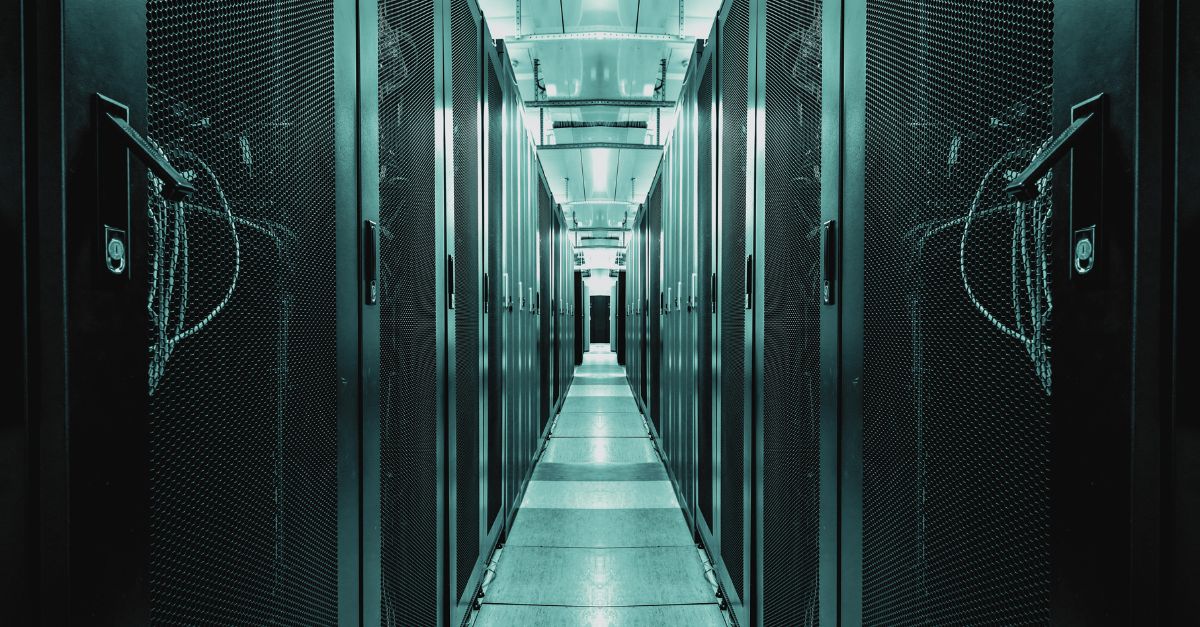 Interior of a modern data centre with rows of server racks, highlighting the importance of efficient, sustainable infrastructure in the digital age. Navitas Resourcing Group connects top talent for green data centre projects.