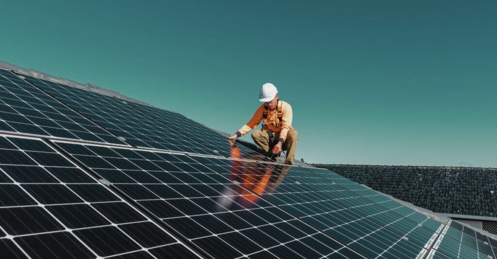 A technician working on solar panels, helping to drive the clean energy revolution. Navitas Resourcing Group connects top talent to solar energy projects.