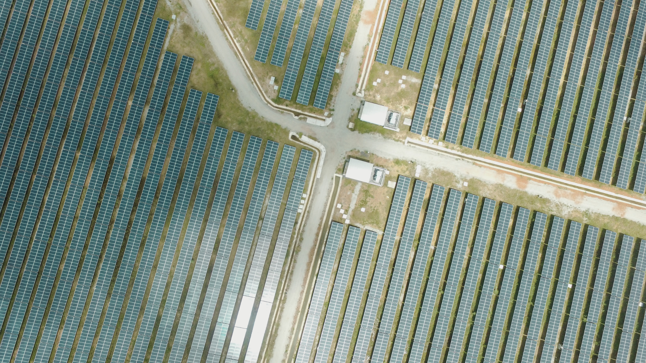 Aerial view of a large utility-scale solar farm with neatly arranged rows of solar panels and access roads. These expansive solar installations are a key driver in the U.S. renewable energy push, helping to meet growing electricity demands. As solar and battery storage dominate planned capacity additions in 2025, Navitas Resourcing Group continues to support the recruitment of top talent shaping the future of clean energy.