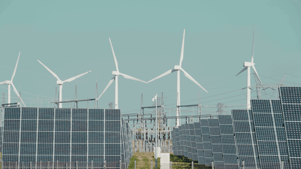 Wind turbines and solar panels at a renewable energy facility generating clean power