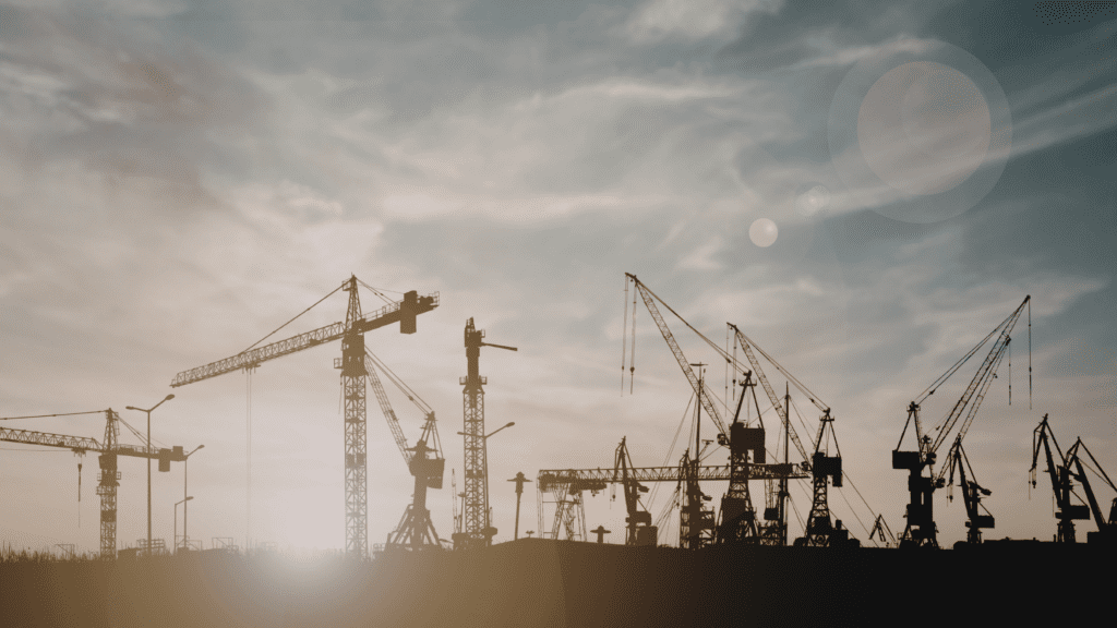 Construction cranes working on large-scale infrastructure projects in Europe, representing growth in data centre construction and digital infrastructure development