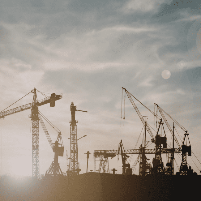 Construction cranes working on large-scale infrastructure projects in Europe, representing growth in data centre construction and digital infrastructure development