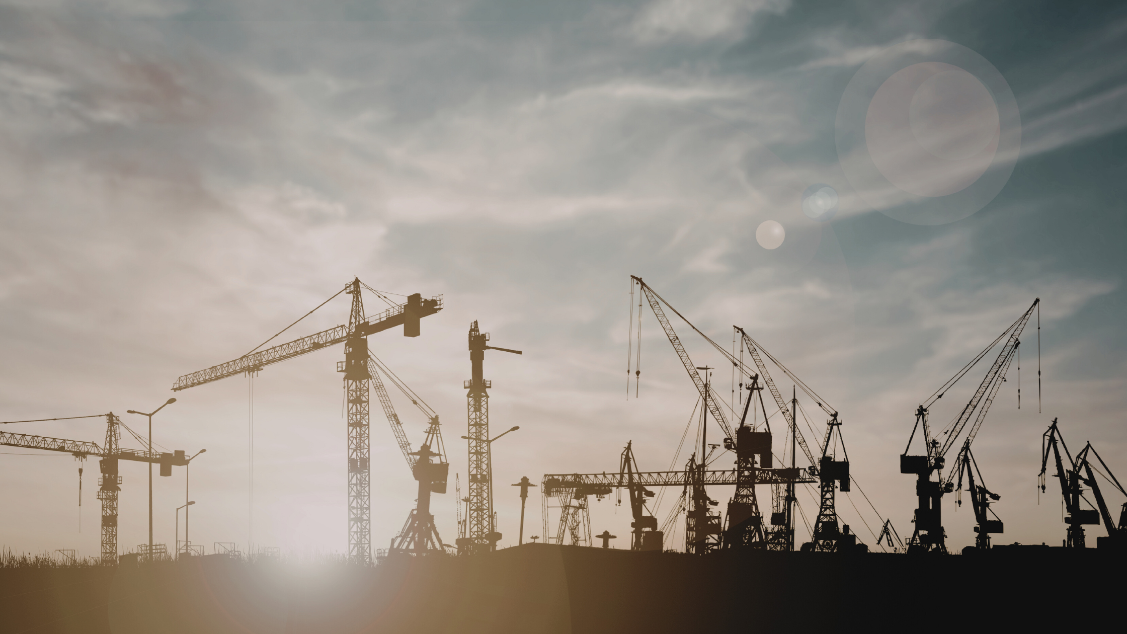 Construction cranes working on large-scale infrastructure projects in Europe, representing growth in data centre construction and digital infrastructure development