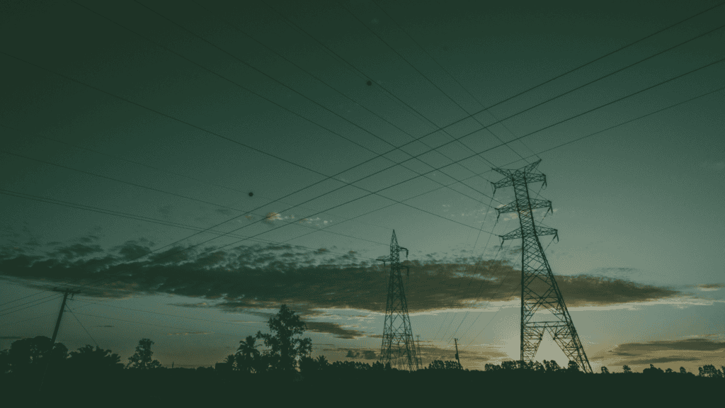Electricity transmission pylons and power lines representing UK grid connections and renewable energy infrastructure.