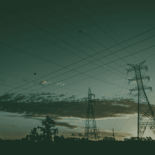 Electricity transmission pylons and power lines representing UK grid connections and renewable energy infrastructure.