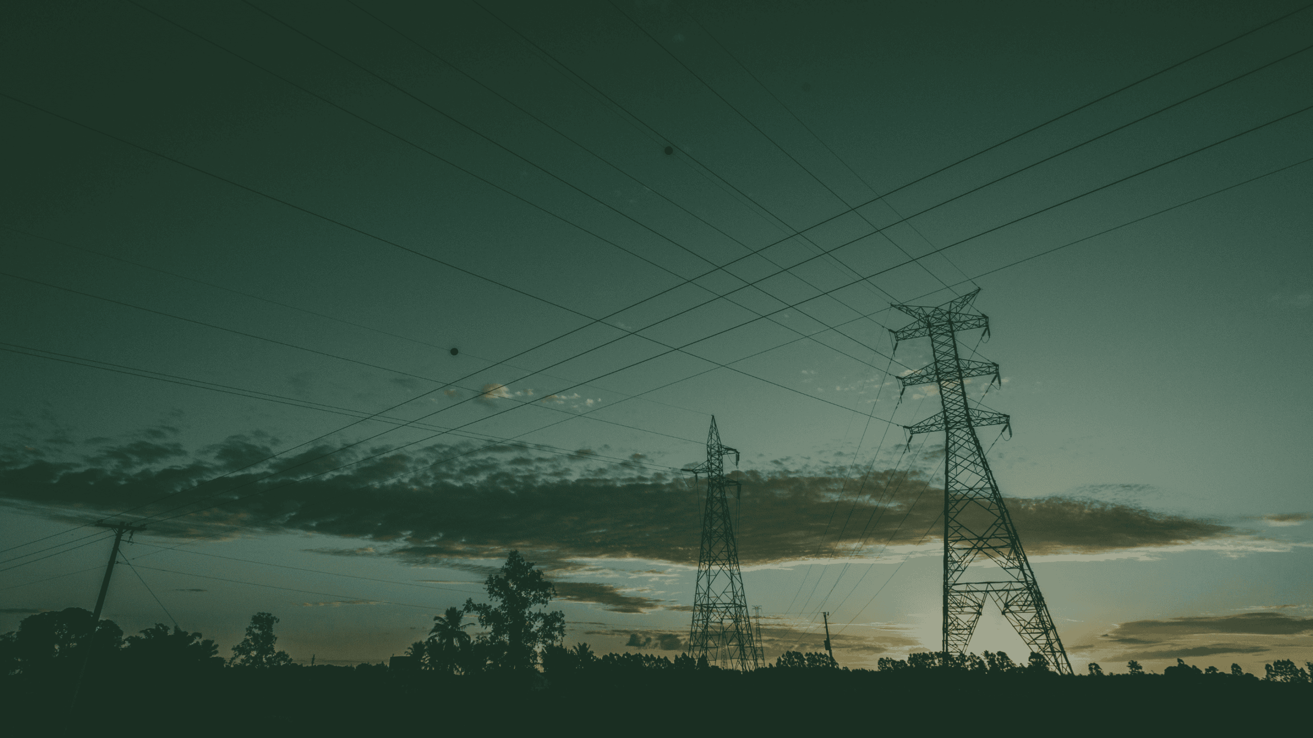 Electricity transmission pylons and power lines representing UK grid connections and renewable energy infrastructure.